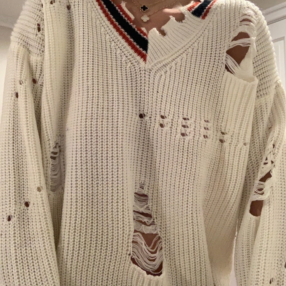 Distressed white sweater.